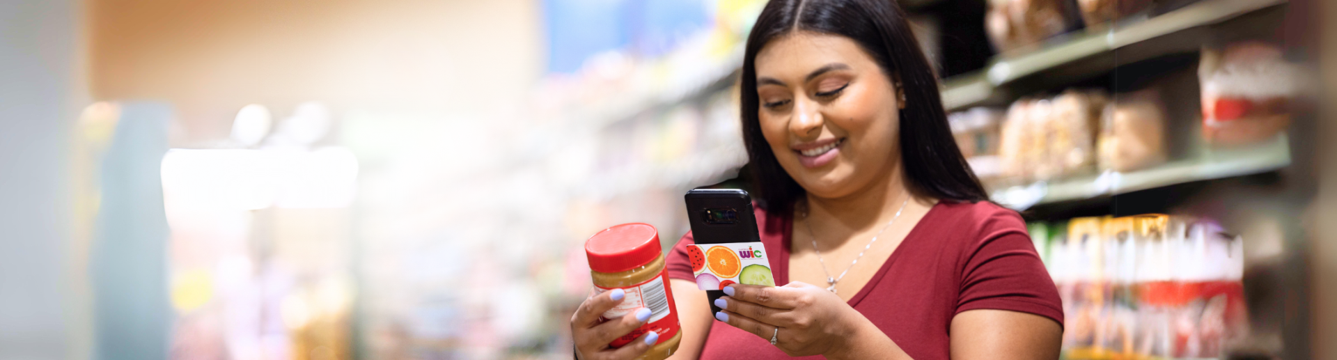 woman_holding_a_phone_and_wic_card