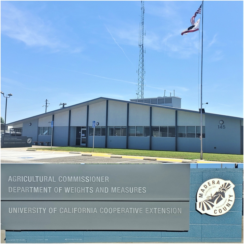 Picture of the front of Agricultural Commissioner building, with a light blue and blue-gray brick signage